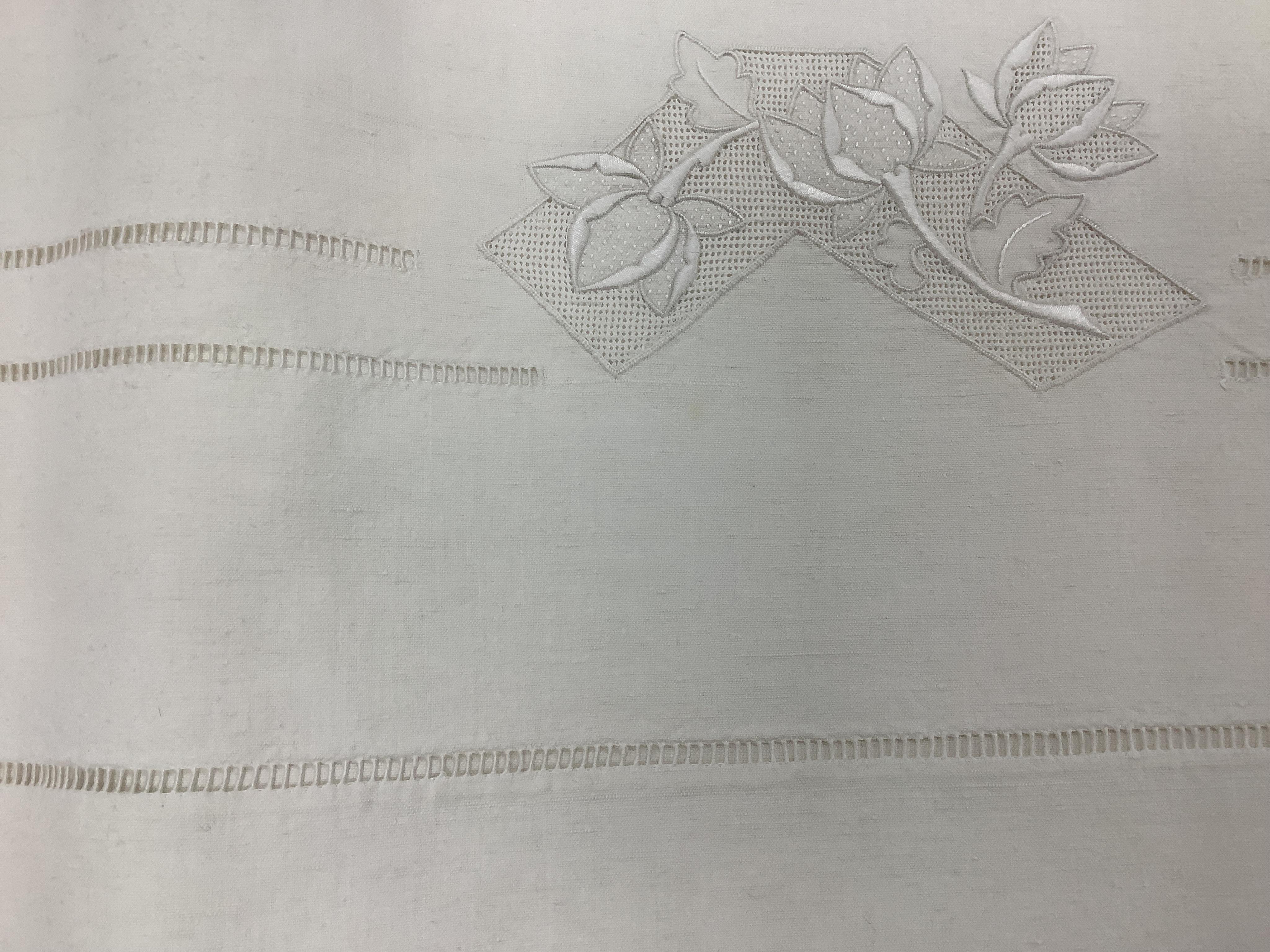 Four French provincial linen floral embroidered and drawn thread turn back, wide and long top sheets. Each sheet with different embroidery, dimensions and shades of linen, being ecru to off white. Condition - ecru sheet,